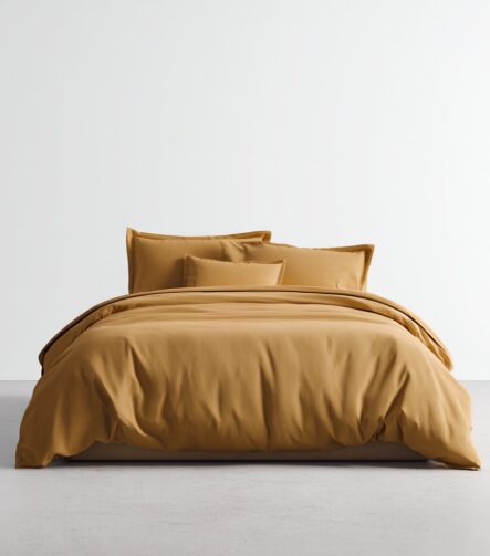 Cotton Sateen Bed Sheets — styled on a neatly made bed