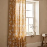 Pinch Pleat Sheer Curtains — hung at a window