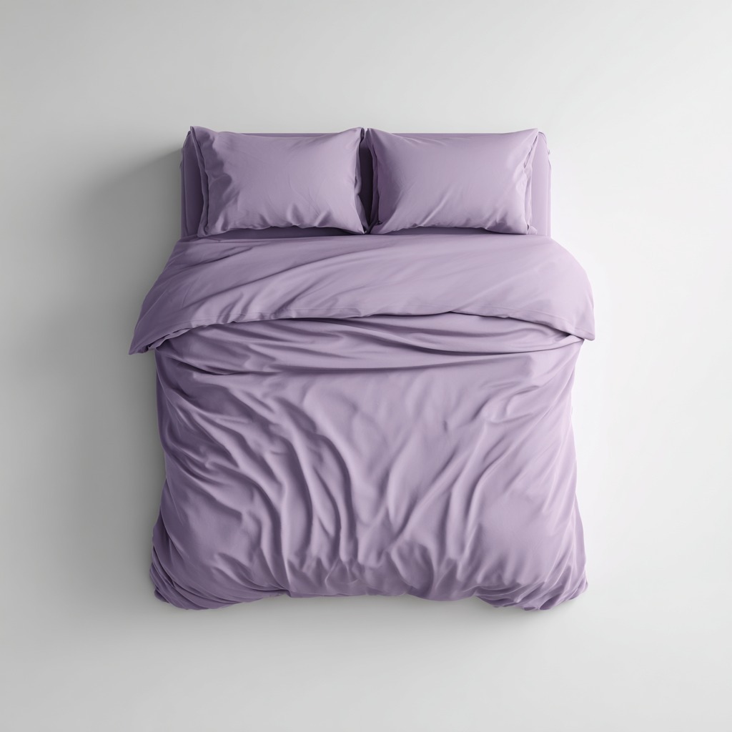 Purple bed sheets in lavender to aubergine sateen cotton on a made bed