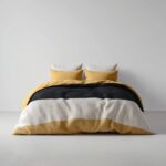 Quilted Throw — folded on a bed