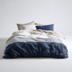 White Bedspread — draped over a bed